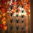 dekoracja na halloween naklejki foliowe pajaki czarne ozdoba 14 szt